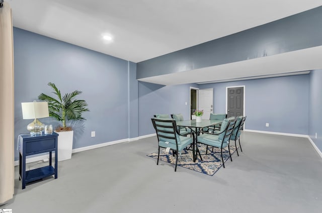 dining space featuring concrete flooring