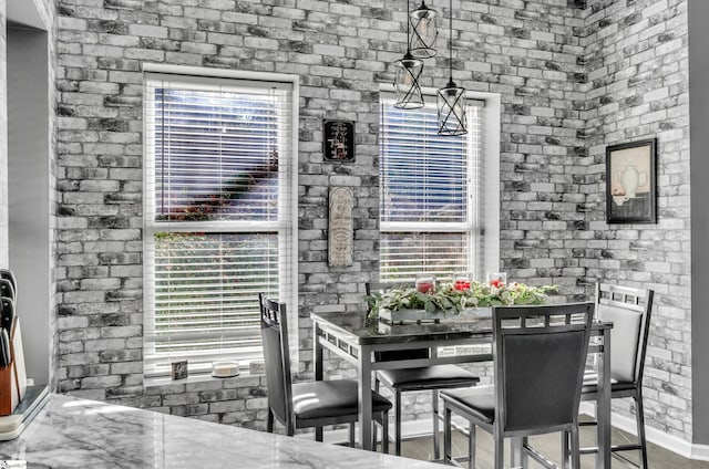 dining space with brick wall