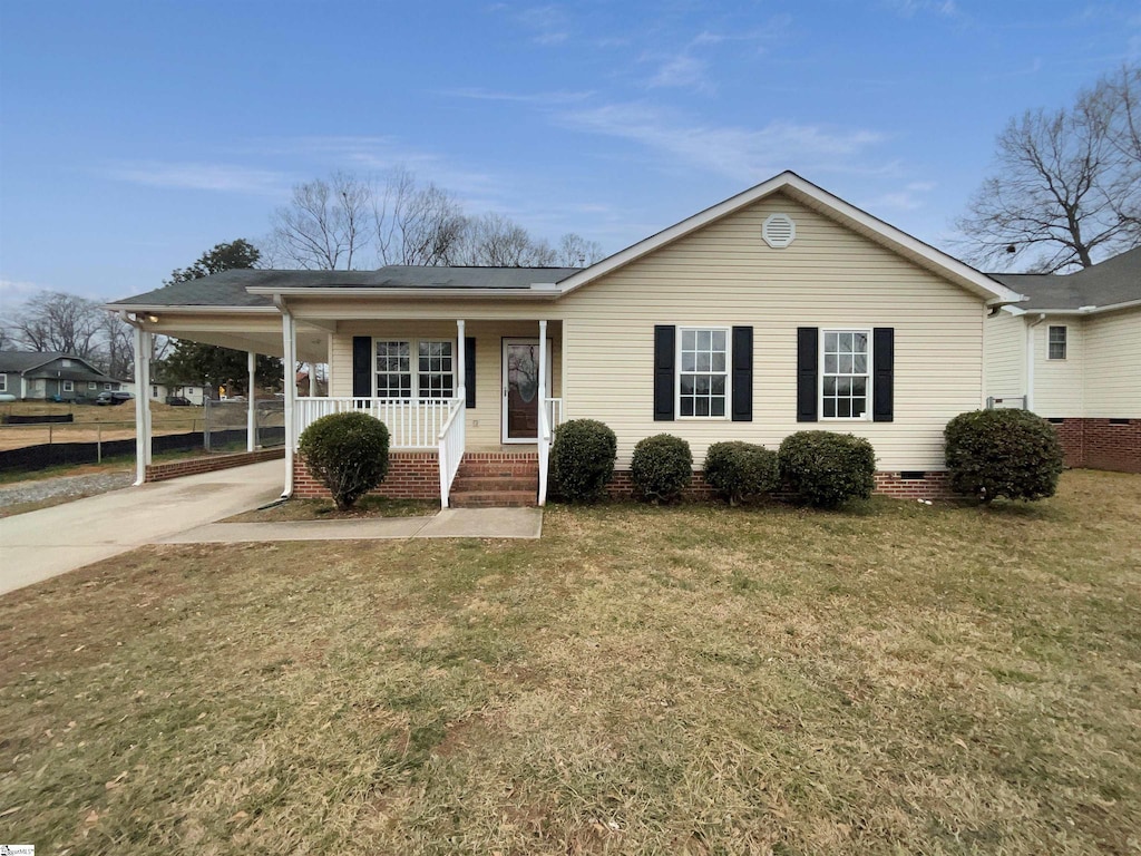 view of front of property with a front yard, a carport, and a porch