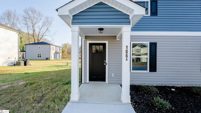 view of exterior entry with a lawn