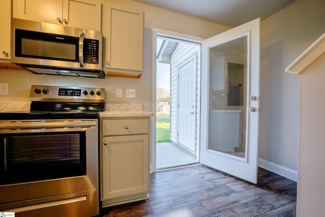 kitchen with white cabinetry, dark hardwood / wood-style flooring, and stainless steel appliances