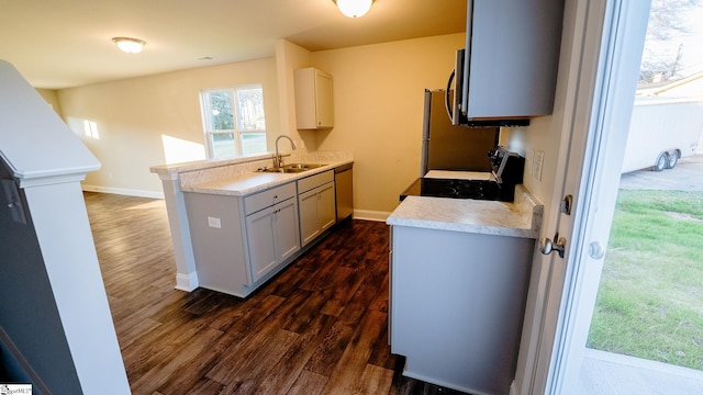 kitchen with gray cabinets, sink, dark hardwood / wood-style flooring, and stainless steel appliances