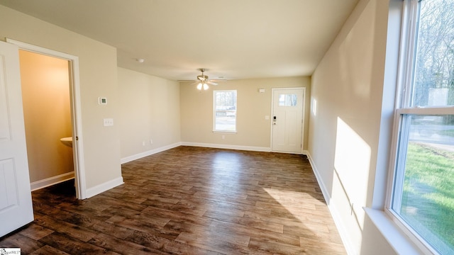 interior space with ceiling fan, dark hardwood / wood-style floors, and a wealth of natural light