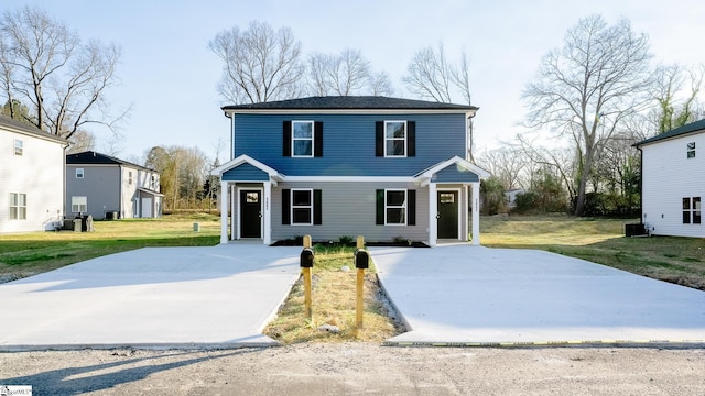 view of front facade featuring a front lawn and central air condition unit