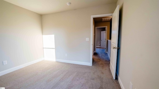 unfurnished room featuring light carpet