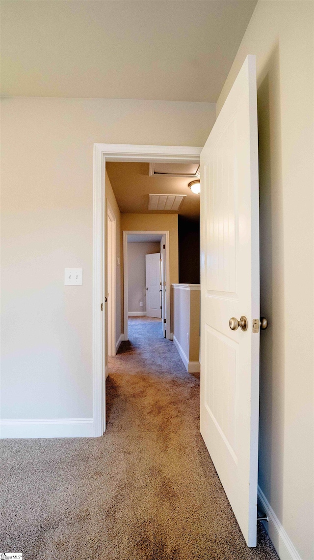 hallway with carpet floors