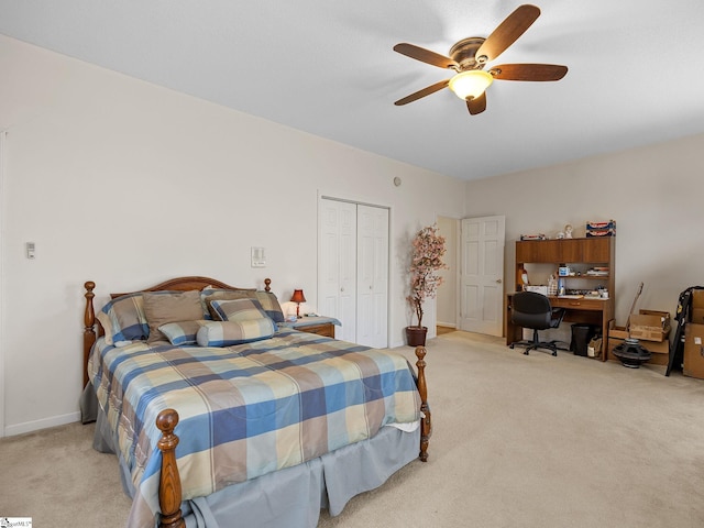 carpeted bedroom with ceiling fan and a closet