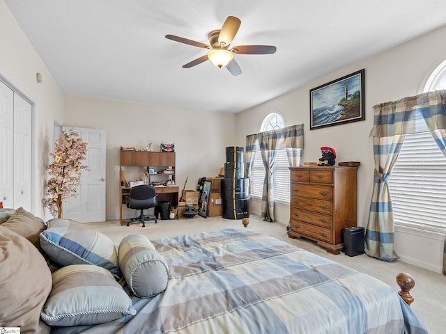 carpeted bedroom with a closet and ceiling fan