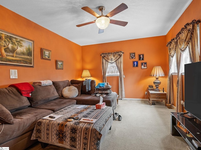 carpeted living room featuring a textured ceiling and ceiling fan