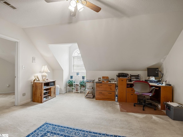 carpeted office space featuring ceiling fan, a textured ceiling, and lofted ceiling