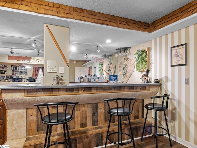 bar featuring hardwood / wood-style floors and a textured ceiling