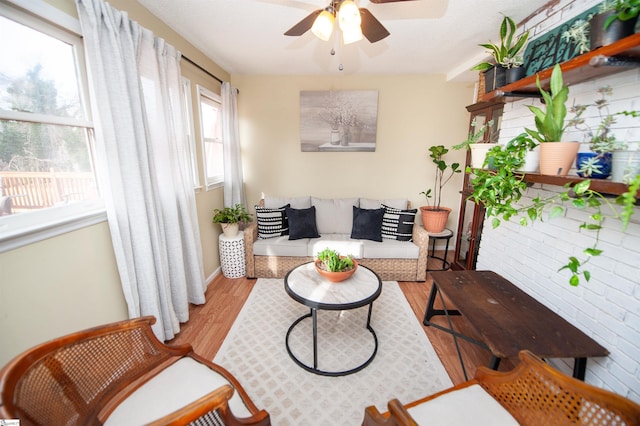 living room featuring ceiling fan and light hardwood / wood-style flooring