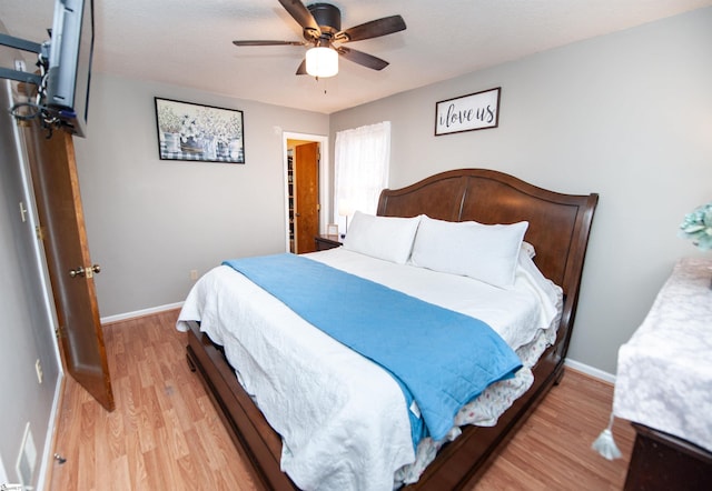 bedroom with ceiling fan and light hardwood / wood-style floors