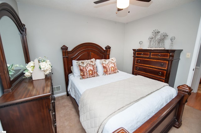 bedroom with ceiling fan and light carpet