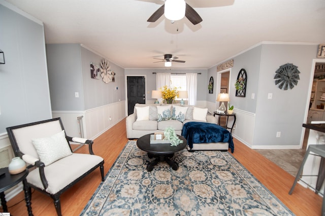 living room featuring light hardwood / wood-style floors and ornamental molding