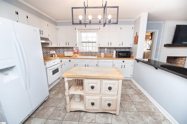 kitchen featuring white appliances, wood counters, decorative light fixtures, white cabinetry, and sink