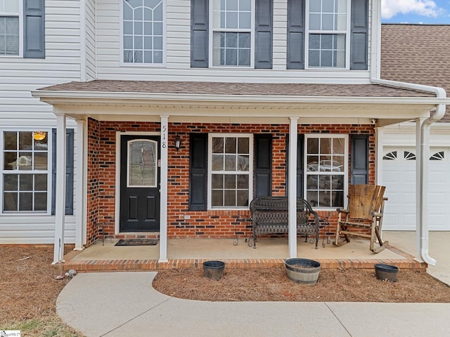 property entrance featuring a garage and covered porch