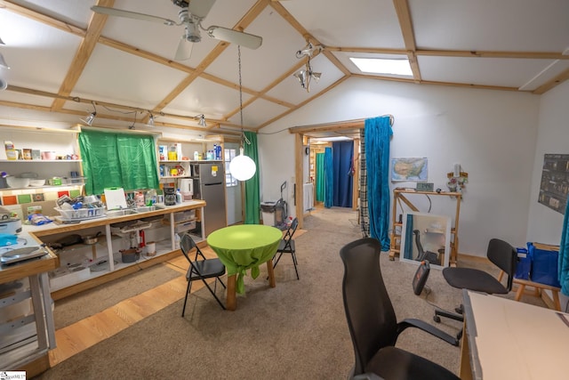 home office with light hardwood / wood-style flooring, vaulted ceiling, and ceiling fan