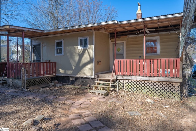 back of house featuring a wooden deck