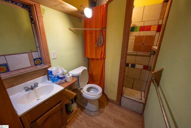 bathroom featuring vanity, hardwood / wood-style flooring, and toilet