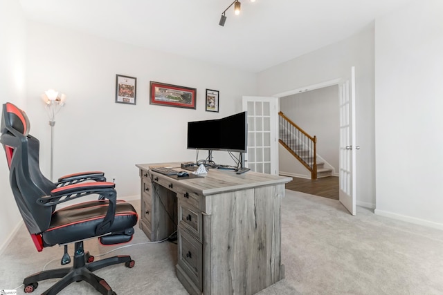 office with light colored carpet and french doors