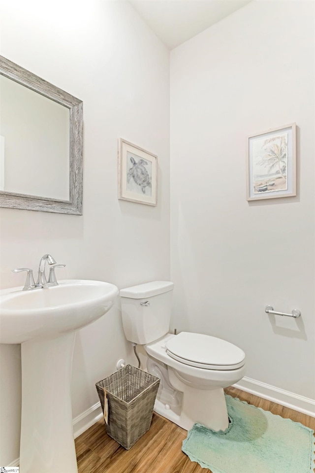 bathroom with sink, hardwood / wood-style flooring, and toilet