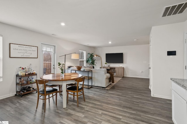 dining space with dark wood-type flooring