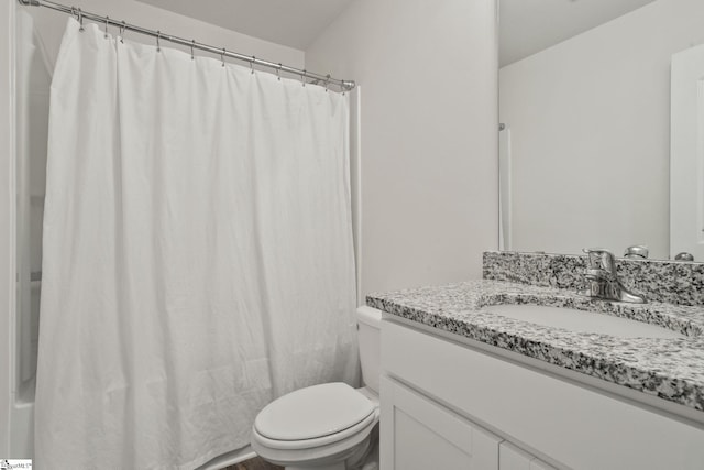 full bathroom featuring shower / bath combination with curtain, vanity, and toilet