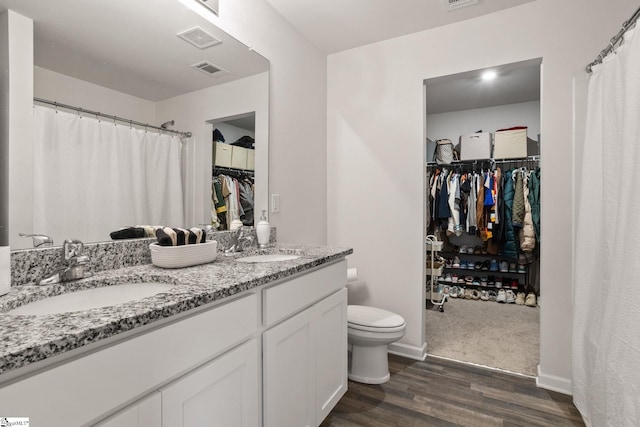 bathroom with vanity, hardwood / wood-style floors, and toilet