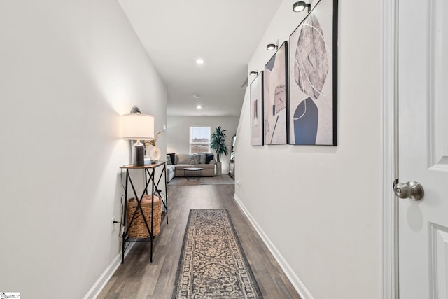 hallway with dark hardwood / wood-style floors