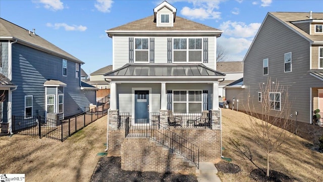 view of front of property featuring a standing seam roof, metal roof, and a porch