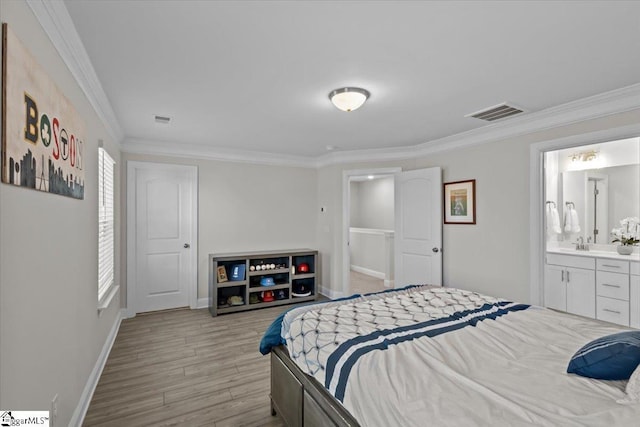 bedroom featuring crown molding, ensuite bath, sink, and light wood-type flooring