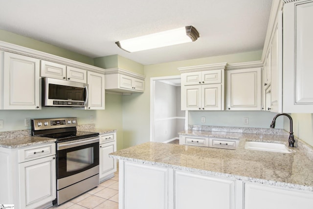 kitchen featuring white cabinetry, sink, stainless steel appliances, and kitchen peninsula