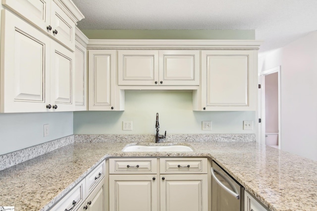 kitchen featuring light stone counters, sink, and stainless steel dishwasher