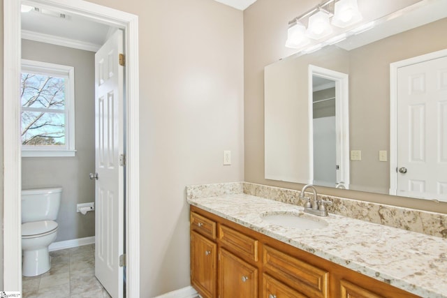 bathroom with crown molding, vanity, and toilet