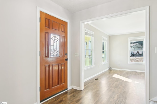 foyer entrance with dark hardwood / wood-style floors and a textured ceiling