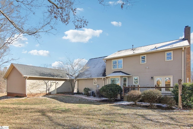 rear view of house with a yard, central AC, and a deck