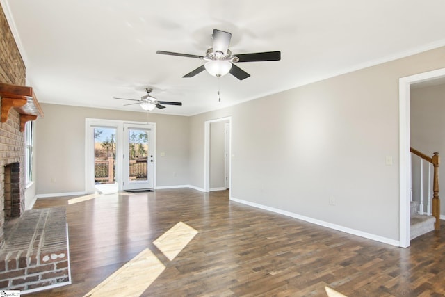 unfurnished living room featuring dark wood-type flooring, a fireplace, and ornamental molding