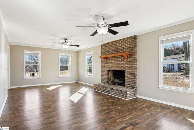 unfurnished living room featuring a fireplace, crown molding, and a wealth of natural light