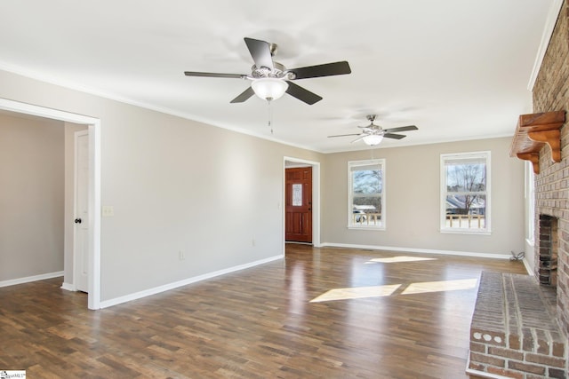 unfurnished living room with dark hardwood / wood-style flooring, a brick fireplace, and crown molding