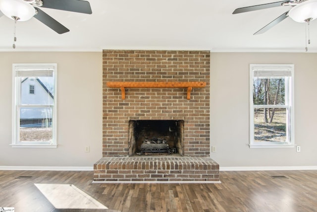 living room featuring hardwood / wood-style floors, a fireplace, and ceiling fan