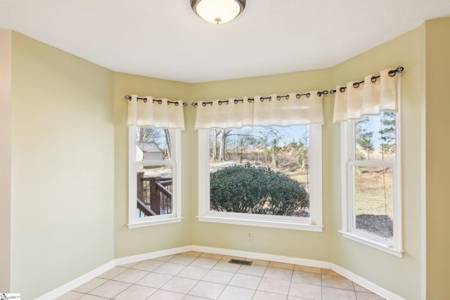 unfurnished dining area featuring light tile patterned floors