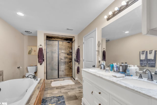 full bathroom featuring vanity, toilet, and separate shower and tub