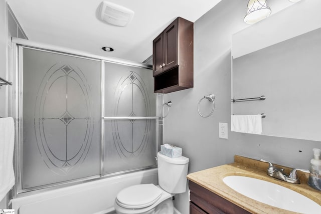 full bathroom featuring shower / bath combination with glass door, vanity, and toilet