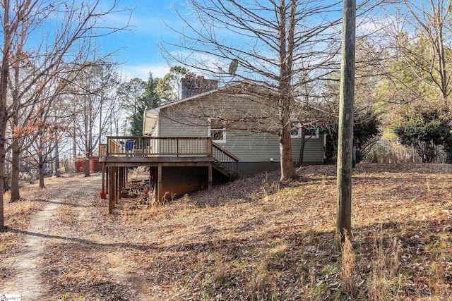 back of property featuring a wooden deck