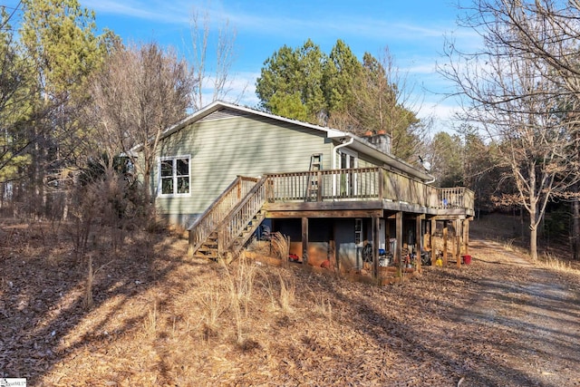 back of property featuring a wooden deck