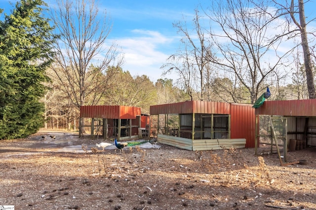 back of house with an outdoor structure