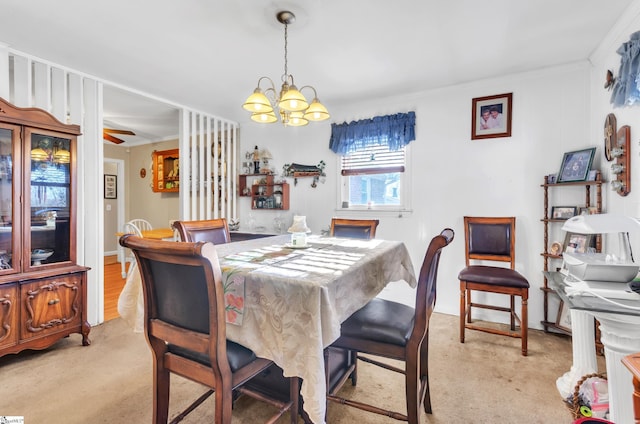 carpeted dining space featuring a chandelier