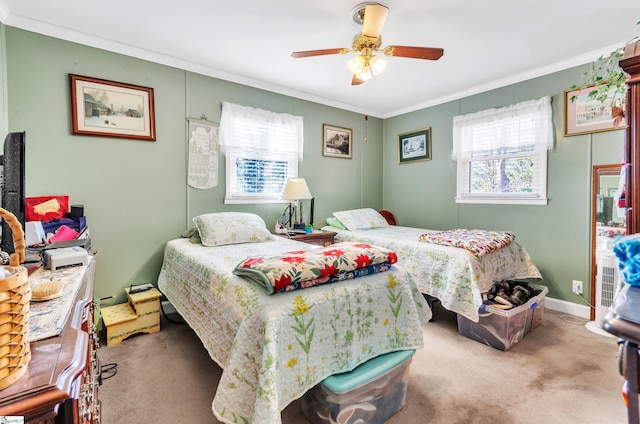 bedroom with carpet floors, ornamental molding, and ceiling fan