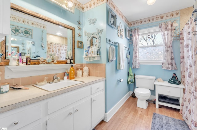 bathroom featuring walk in shower, toilet, tasteful backsplash, vanity, and hardwood / wood-style floors